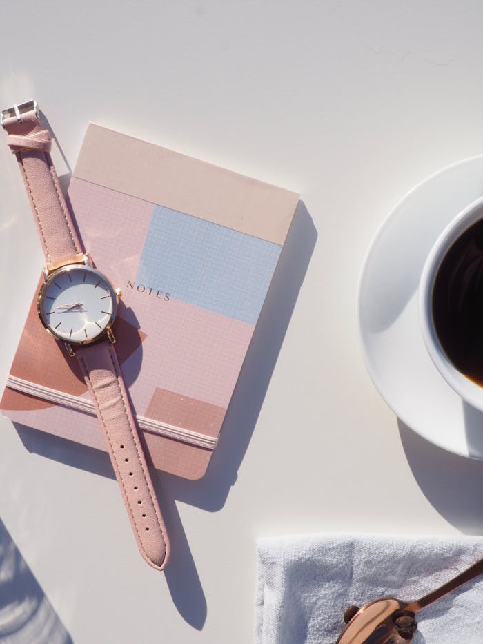 Avasta oma mõtete jõud – 2 nädalat teadlikku fookust Elegant flat lay with wristwatch, notebook, and coffee, perfect for modern lifestyle themes.