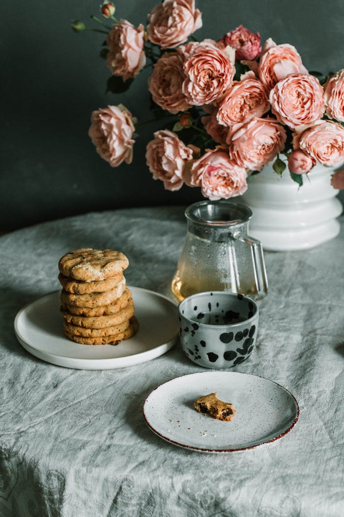 Enjoy rustic elegance with homemade cookies and tea beside vintage floral decor.